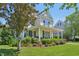 Charming two-story home with a welcoming front porch and beautifully landscaped front yard at 1104 Dominion Hill Dr, Cary, NC 27519