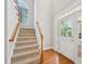 Bright foyer with hardwood floors, a staircase, and a front door that welcomes natural light at 1104 Dominion Hill Dr, Cary, NC 27519