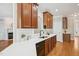 Gourmet kitchen featuring quartz countertops, wood cabinets, and stainless steel appliances at 1104 Dominion Hill Dr, Cary, NC 27519
