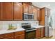 Modern kitchen featuring stainless steel appliances, wood cabinetry at 1104 Dominion Hill Dr, Cary, NC 27519