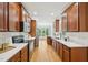 Open kitchen featuring wood cabinets, quartz countertops, and eat-in area at 1104 Dominion Hill Dr, Cary, NC 27519