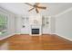 Open-concept living room featuring a fireplace with custom built-ins and a cozy atmosphere at 1104 Dominion Hill Dr, Cary, NC 27519