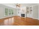 Spacious living room with a fireplace, built-in bookshelves, and hardwood floors, perfect for entertaining at 1104 Dominion Hill Dr, Cary, NC 27519