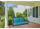 Relaxing porch swing with plush cushions, set against a backdrop of lush greenery and the home's exterior at 1104 Dominion Hill Dr, Cary, NC 27519