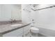 Bathroom features a granite vanity top and a white tiled shower and tub with black accent tiles at 114 Cross Country Way, Durham, NC 27703