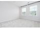 Carpeted bedroom featuring two windows providing natural light at 114 Cross Country Way, Durham, NC 27703
