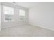 Carpeted bedroom with two windows providing natural light at 114 Cross Country Way, Durham, NC 27703