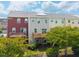 Exterior view of the back of townhomes featuring individual decks, and solar panels on the roofs at 114 Cross Country Way, Durham, NC 27703