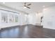 Living room features dark wood floors, recessed lighting, and large bright windows at 114 Cross Country Way, Durham, NC 27703