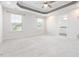 Large bedroom features a tray ceiling, neutral carpet, and an ensuite bathroom at 114 Cross Country Way, Durham, NC 27703