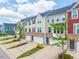 Row of townhomes with attached garages, brick facades, and beautifully landscaped front yards at 114 Cross Country Way, Durham, NC 27703