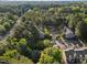 Aerial view of complex showing building roofs, parking lots and lots of trees at 117 Candace Pl, Cary, NC 27513