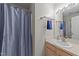 Bathroom featuring a sink with brushed nickel faucet and a shower with a blue curtain at 117 Candace Pl, Cary, NC 27513