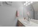 A light-filled bathroom offers a single sink vanity with a large mirror and decorative wall accents at 117 Candace Pl, Cary, NC 27513