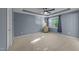 Empty bedroom showcasing a ceiling fan, decorative ceiling and sunlit windows at 117 Candace Pl, Cary, NC 27513