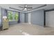 An empty bedroom showcasing a ceiling fan, decorative ceiling and a sunlit window at 117 Candace Pl, Cary, NC 27513