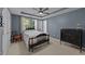 Cozy bedroom featuring a decorative ceiling, ceiling fan, window views, and traditional furnishings at 117 Candace Pl, Cary, NC 27513