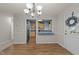 Open dining area with wood floors, chandelier, and a pass-through to the kitchen at 117 Candace Pl, Cary, NC 27513