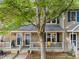 Charming home featuring a covered front porch, blue shutters, and a well-maintained yard at 117 Candace Pl, Cary, NC 27513