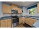 Well-equipped kitchen with stainless steel appliances, wooden cabinets, and blue countertops at 117 Candace Pl, Cary, NC 27513
