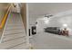 Spacious living room with staircase, fireplace, ceiling fan and plush gray sofa at 117 Candace Pl, Cary, NC 27513