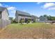 Large backyard with a brick patio, screened porch, and a firepit at 117 Woodlark Ln, Holly Springs, NC 27540