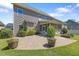 Landscaped backyard with a brick patio, lush green lawn, and mature trees at 117 Woodlark Ln, Holly Springs, NC 27540