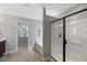 Bathroom view featuring walk-in shower, soaking tub, and large window with natural lighting at 117 Woodlark Ln, Holly Springs, NC 27540