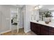 Bathroom showing a double vanity with dark wood cabinetry and a view to the main bedroom at 117 Woodlark Ln, Holly Springs, NC 27540
