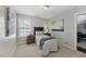A well-lit bedroom with a bed, side tables, and a window at 117 Woodlark Ln, Holly Springs, NC 27540