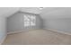 Attic bedroom with neutral carpet and natural light at 117 Woodlark Ln, Holly Springs, NC 27540