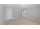 Neutral bedroom featuring a walk-in closet and neutral carpet at 117 Woodlark Ln, Holly Springs, NC 27540