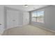 Bright bedroom with a window and double door closet at 117 Woodlark Ln, Holly Springs, NC 27540