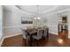 Elegant dining room with dark wood table, six upholstered chairs, wainscoting, and tray ceiling at 117 Woodlark Ln, Holly Springs, NC 27540