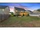 Beautiful home featuring a large backyard with patio, firepit, and screened-in porch at 117 Woodlark Ln, Holly Springs, NC 27540