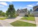 Charming home featuring a manicured lawn, two car garage, and stone and gray shingle exterior at 117 Woodlark Ln, Holly Springs, NC 27540