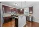 Beautiful kitchen with stainless steel appliances, granite countertops, and dark wood cabinets at 117 Woodlark Ln, Holly Springs, NC 27540
