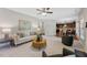 Inviting living room with neutral tones, plush seating, and seamless flow into the kitchen and dining areas at 117 Woodlark Ln, Holly Springs, NC 27540
