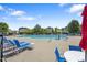 Community pool featuring plentiful lounge seating, mature landscaping, and a mushroom water feature at 117 Woodlark Ln, Holly Springs, NC 27540