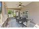 Relaxing screened porch with an outdoor dining area and ceiling fan at 117 Woodlark Ln, Holly Springs, NC 27540