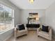 Cozy sitting room features plush chairs, a dark wood console table, and a large window at 117 Woodlark Ln, Holly Springs, NC 27540