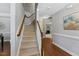 Carpeted staircase features wood railings, offering a smooth transition between floors at 117 Woodlark Ln, Holly Springs, NC 27540