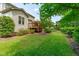 Picturesque backyard featuring a deck, lush greenery, and a well-manicured lawn at 1401 Everette Fields Rd, Morrisville, NC 27560