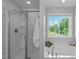 Bright bathroom with tub, separate shower and nature views at 1401 Everette Fields Rd, Morrisville, NC 27560