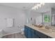 Bright bathroom with dual sinks, blue vanity and modern fixtures at 1401 Everette Fields Rd, Morrisville, NC 27560