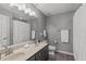 Modern bathroom with double sink vanity, large mirror, shower with white curtain, and gray walls at 1401 Everette Fields Rd, Morrisville, NC 27560