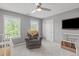 Cozy bedroom with comfortable recliner, ceiling fan and carpeted floors at 1401 Everette Fields Rd, Morrisville, NC 27560