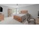Well-lit bedroom boasts a wood bed frame, natural light from two windows, and a built-in bookcase at 1401 Everette Fields Rd, Morrisville, NC 27560