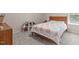 Cozy bedroom featuring a comfortable bed with colorful accents, a dollhouse, and a window at 1401 Everette Fields Rd, Morrisville, NC 27560