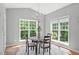 Cozy breakfast nook with a round table, chandelier, and natural light from surrounding windows at 1401 Everette Fields Rd, Morrisville, NC 27560